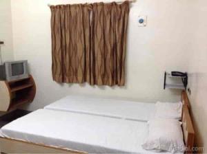 a small room with a bed and a window at Le Palace in Gūduvāncheri +1 photo