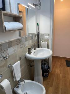 a bathroom with a white sink and a mirror at A Casuzza in Pollina