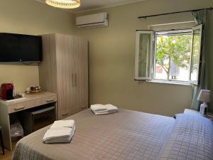 a bedroom with a bed with two towels on it at A Casuzza in Pollina
