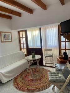 a living room with a couch and a table at Hostal Cholo in Brañosera