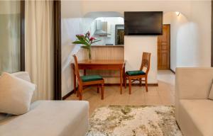 a living room with a table and a couch at Eden's Holiday Villas in Mahe