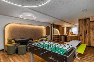 ein Spielzimmer mit einem Tischkicker und einem Schachbrett in der Unterkunft Ravelli Sporting in Mezzana