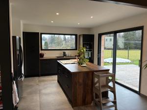 a kitchen with a counter and a large window at Aloha House 88 in Le Val-dʼAjol +14 photos