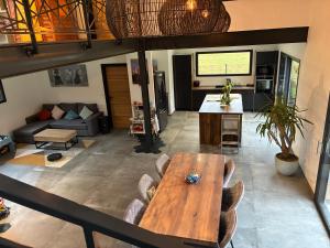 a living room with a table and a couch at Aloha House 88 in Le Val-dʼAjol