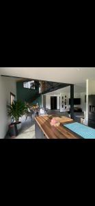 a large kitchen and living room with a table at Aloha House 88 in Le Val-dʼAjol