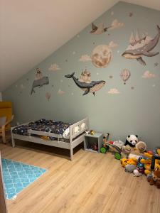 a childs room with a bed and planets on the wall at Aloha House 88 in Le Val-dʼAjol