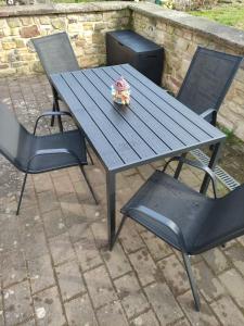a picnic table with two chairs and a sandwich on it at Ferienwohnung Mandy in Morsleben