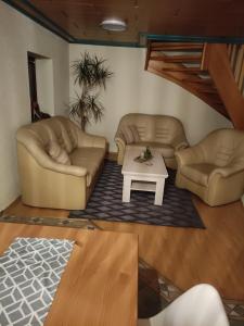 a living room with two couches and a coffee table at Ferienwohnung Mandy in Morsleben