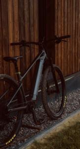 a bike parked next to a wooden fence at oto.domki in Rokiciny Podhalanskie