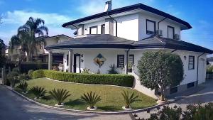 a large white house with a landscaping at APPARTAMENTO in seminterrato PALMAROLA in Sabaudia