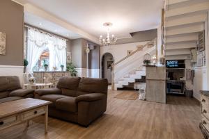 a living room with a couch and a staircase at Grotta dei Puntali B&B in Carini