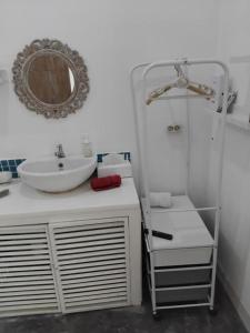 a bathroom with a sink and a mirror at Jimbaran room 01 in Jimbaran +51 photos