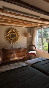 a bedroom with a bed and a mirror on the wall at Casa La Sendera Alojamiento Rural en La Rioja in Santa Engracia