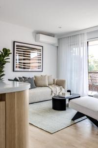 a living room with a couch and a table at Medusa Bondi in Sydney