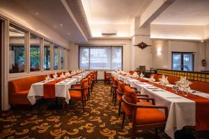 a row of tables and chairs in a room at West End Hotel Opp Bombay Hospital in Mumbai