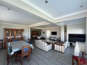 a living room with a table and a tv at 87 Marine Drive in Struisbaai