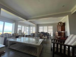a living room with a table and chairs at 87 Marine Drive in Struisbaai