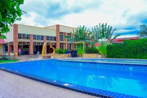 a large swimming pool in front of a building at The Residence Hotel Dodoma in Dodoma