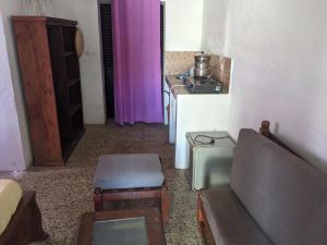 a living room with a couch and purple curtains at Sam in Mahajanga