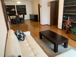 a living room with a white couch and a coffee table at Pension Belascu in Sibiu