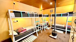 a room with three bunk beds in a room at Piti khangpa in Kaza
