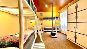 a bunk bed room with two bunk beds and a staircase at Piti khangpa in Kaza