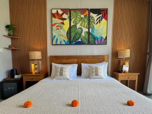 a bedroom with a bed with two oranges on it at The Palms Canggu in Canggu