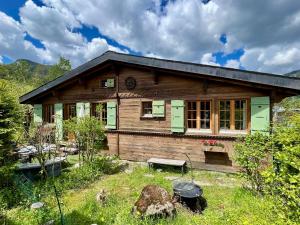a wooden house in the middle of a field at Gstaad Chalet in Gstaad