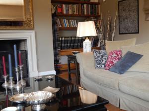 a living room with a couch and a fireplace at Slow living beautiful villa in Rafina