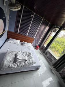 a bed in a room with two windows at Taj hotel in Hisār