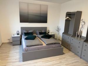 a bedroom with a large bed with two pillows at Ferienhaus Relax in Kösseln +18 photos