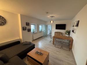 a living room with a couch and a table at Ferienhaus Relax in Kösseln