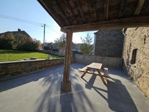 a wooden bench sitting on top of a patio at Lu Stâve in Stoumont