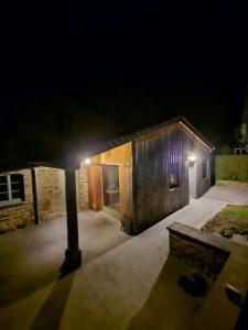 a small wooden building with a light on it at night at Lu Stâve in Stoumont