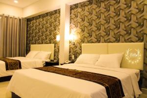 Postel nebo postele na pokoji v ubytování Lilly Hotel