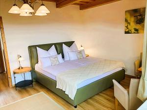 a bedroom with a bed with white sheets and pillows at Weingut- Gästezimmer Marko in Leutschach