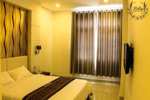Postel nebo postele na pokoji v ubytování Lilly Hotel