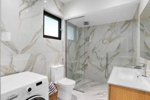 a bathroom with a toilet and a sink at The Palms Seaside - Kolymvari in Kolymvari