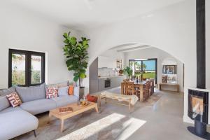 a living room with a couch and a table at The Palms Seaside - Kolymvari in Kolymvari