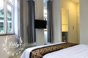 Postel nebo postele na pokoji v ubytování Lilly Hotel