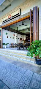 a lobby of a building with tables and chairs at 57 hua hin in Hua Hin