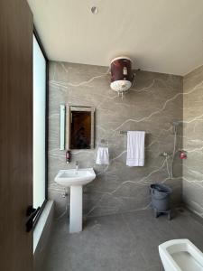 a bathroom with a sink and a toilet and a mirror at Hotel sky inn in Jalandhar