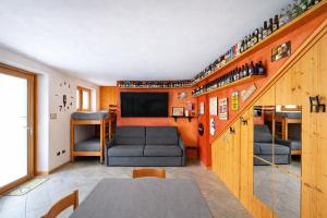 a living room with a staircase with a couch and a tv at Bella Vita Stays Relax in Sondrio