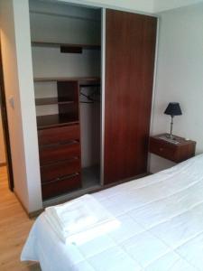 1 dormitorio con cama, tocador y espejo en Bahiaxdia Fitz Roy 140 en Bahía Blanca
