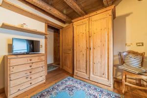 a living room with a tv and a dresser at Da La Auri in Canale dʼAgordo
