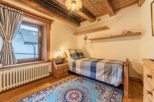 a bedroom with a bed and a window at Da La Auri in Canale dʼAgordo