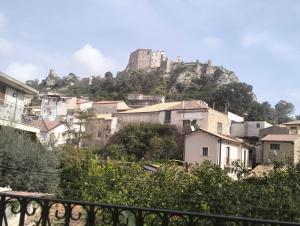 a city with a castle on top of a mountain at terrazza sul castello in Roccella Ionica