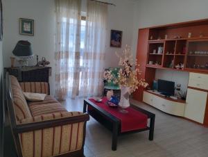 a living room with a couch and a table at terrazza sul castello in Roccella Ionica