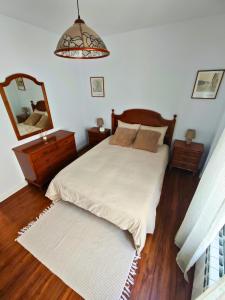 a bedroom with a bed and a large mirror at Apartamento Pena Furada in Ribadeo