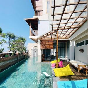 a pool at a villa with a swimming pool at De'Rein Beach House in Sanur